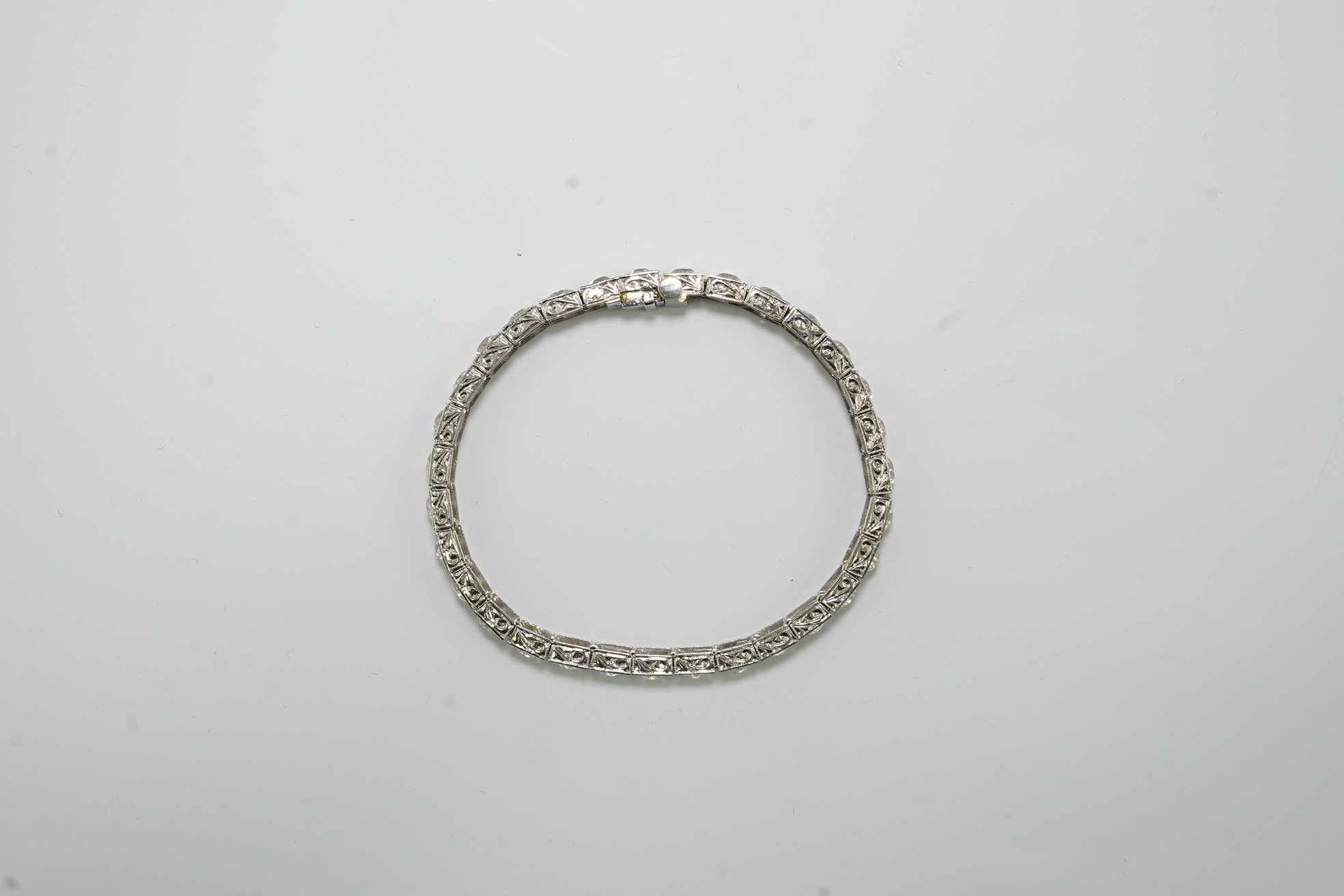 A platinum and thirty one stone round cut diamond set line bracelet